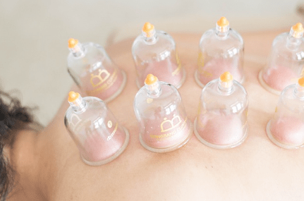 Cupping applied along the back during a massage treatment session