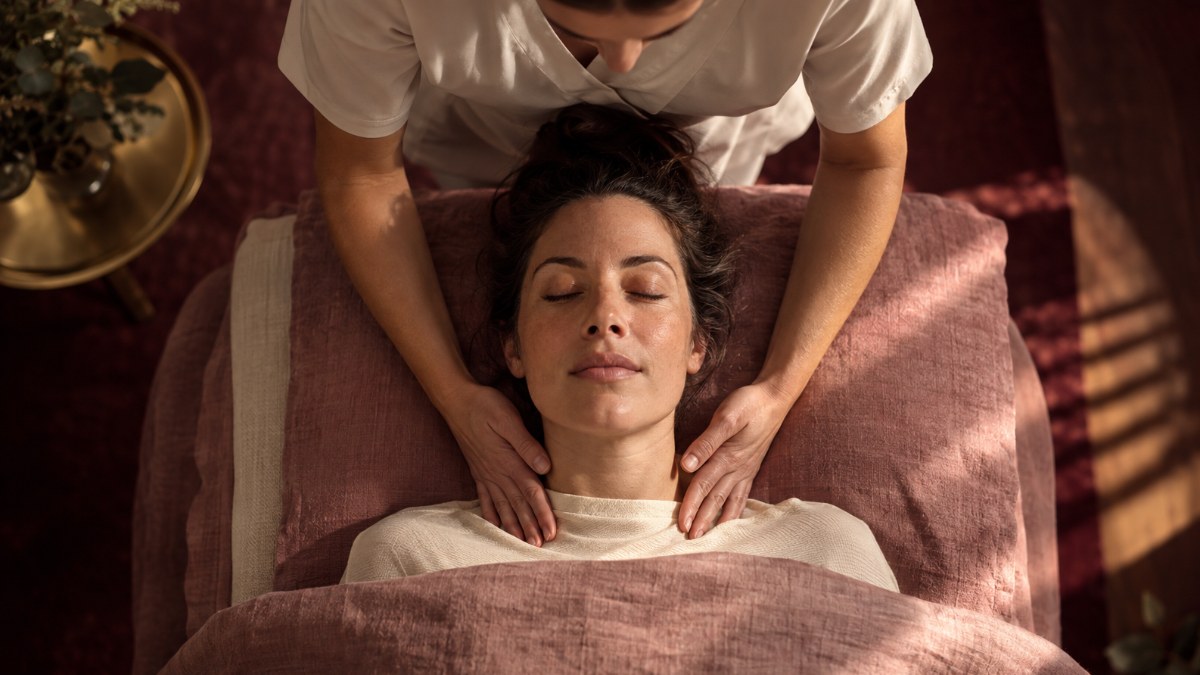 Manual Lymphatic Drainage Neck and Clavicle Houston Therapist's hands performing gentle manual lymphatic drainage at a client's neck and collarbone in Houston