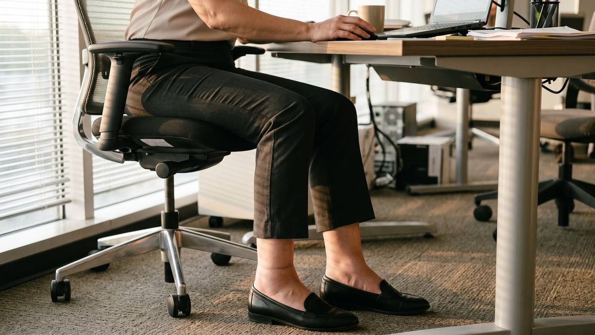 Swollen ankles at the end of a working day, Houston Lower legs and ankles visibly swollen at the end of a day seated at an office desk